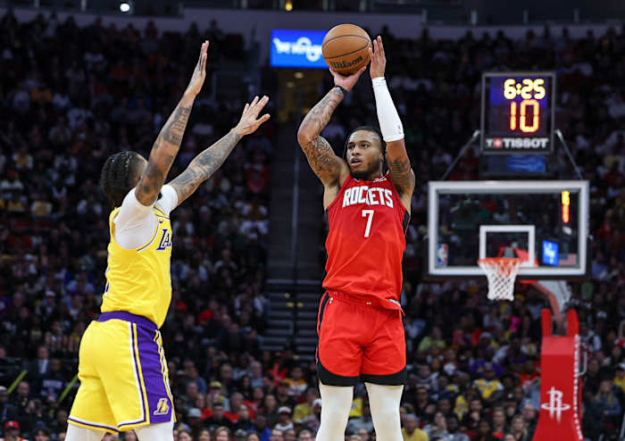 Rockets forward Cam Whitmore (7) shoots the ball as Los Angeles Lakers guard D'Angelo Russell (1) defends during the second quarter at Toyota Center.